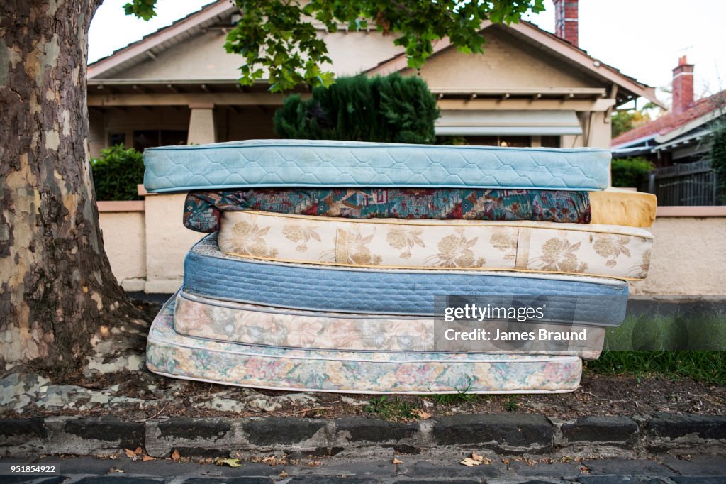 Bed mattresses left out for collection on suburban street