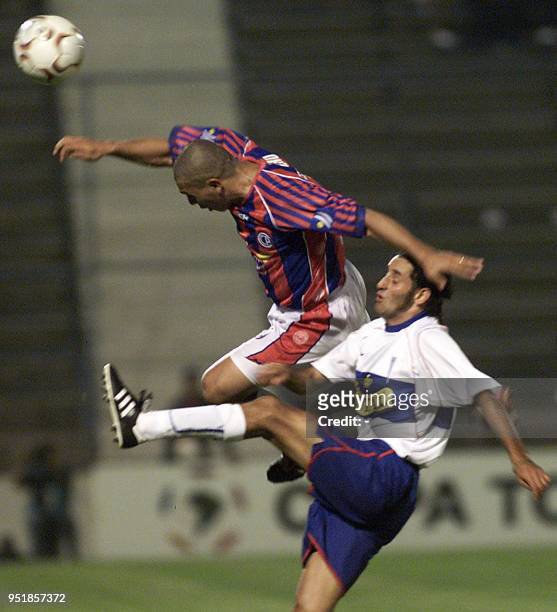 Daniel Achucarro of Cerro Porteno in action against Catholic University's Miguel Ponce, during the Copa Libertadores soccer tournament 18 March 2003...