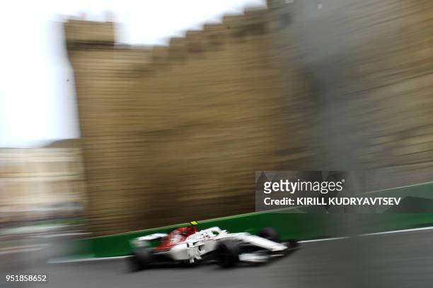 Haas F1's Danish driver Kevin Magnussen steers his car during the first practice session ahead of the Formula One Azerbaijan Grand Prix in Baku on...