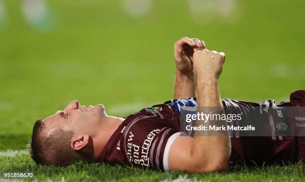 Lachlan Crocker of the Sea Eagles lays down injured during the Round eight NRL match between the Manly-Warringah Sea Eagles and the Newcastle Knights...