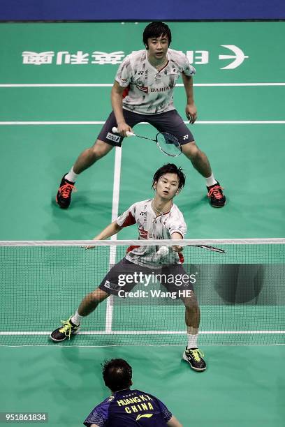 Hiroyuki Endo and Yuta Watanabe of Japan hit a return during women's doubles match against Huang Kaixiang and Wang Yilyu of China at the 2018...