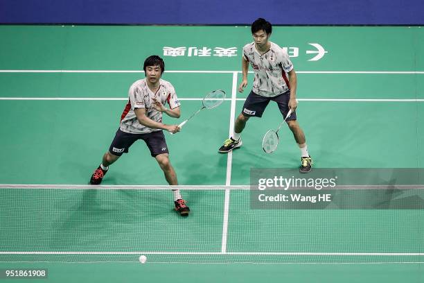 Hiroyuki Endo and Yuta Watanabe of Japan hits a return during women's doubles match against Huang Kaixiang and Wang Yilyu of China at the 2018...