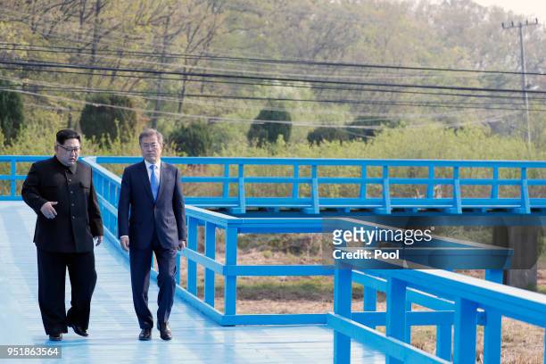 North Korean leader Kim Jong Un and South Korean President Moon Jae-in take a walk on the walk bridge during the Inter-Korean Summit on April 27,...