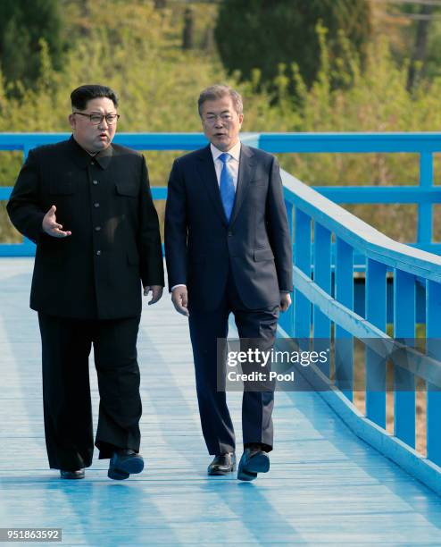 North Korean leader Kim Jong Un and South Korean President Moon Jae-in take a walk on the walk bridge during the Inter-Korean Summit on April 27,...