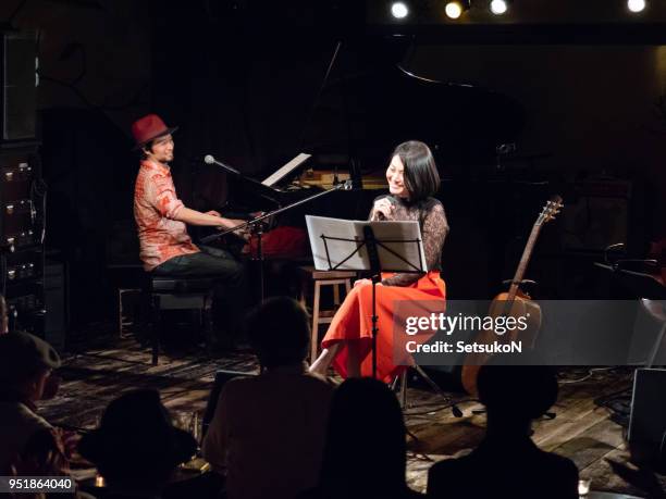 asian musicians, pianist and guitarist, performing on stage - asian pianist stock pictures, royalty-free photos & images