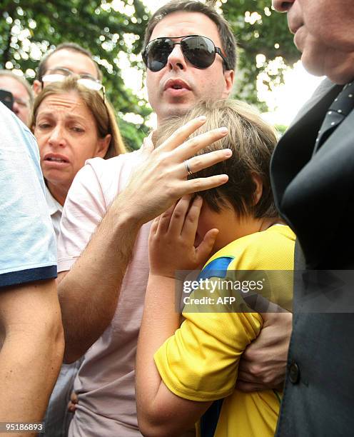 Nine-year-old boy Sean Goldman embraces his stepfather, Brazilian Joao Paulo Lins e Silva, as he arrives also accompanied by his Brazilian...