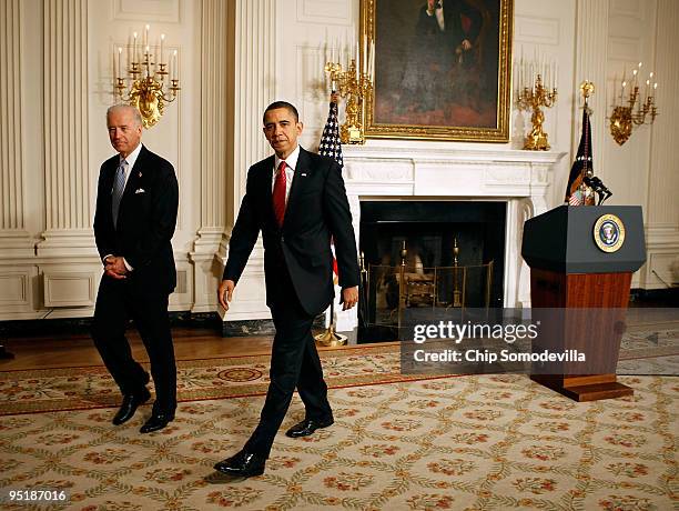 President Barack Obama and Vice President Joe Biden walk away from the podium in the State Dining Room after delivering remarks after the Senate...