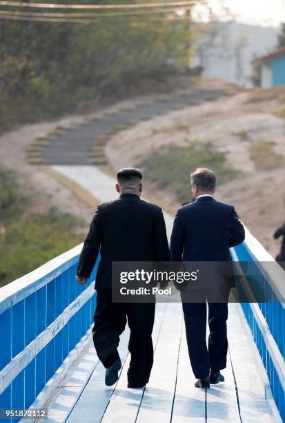 North Korean leader Kim Jong Un and South Korean President Moon Jae-in take a walk on the walk bridge during the Inter-Korean Summit on April 27,...