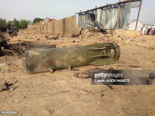 Graphic content / A bomb from air strike by the Nigerian airforce lies on the ground after cross fire between the military and Boko Haram Islamists...