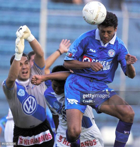 Sergio ALmaguer of the Cruz Azuel hits the ball with his head while Christian Martinez , of Puebla, tries to steal the ball in Mexico City, 20...