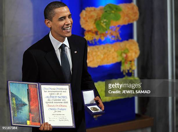 Nobel Peace Prize laureate, US President Barack Obama smiles on the podium with his diploma and gold medal during the Nobel ceremony at the City Hall...