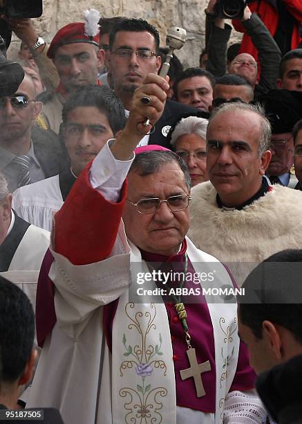 The head of the Roman Catholic Church in the Holy Land, the Latin Patriarch of Jerusalem Fuad Twal, sprinkles holy water outside the Church of the...