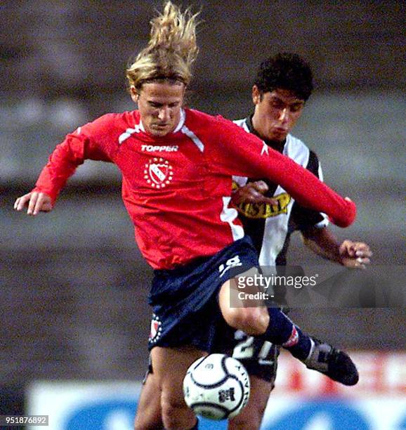 Diego Forlan of the Independiente, fights for the ball against Miguel Riffo, of Colo-Colo Chilean team, in Buenos Aires, 17 October 2001. Diego...