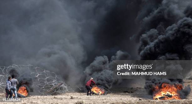 Palestinian demonstrators try to pull down part of the fence on the Israel-Gaza border, east of Gaza City in the central Gaza Strip, during the fifth...