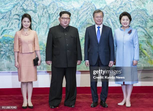 South Korean President Moon Jae In , alongside his wife Kim Jung Sook , and North Korean leader Kim Jong Un , and his wife Ri Sol Ju, pose at the...