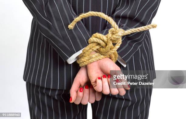 business woman with hands tied behind back - sinnlosigkeit stock-fotos und bilder