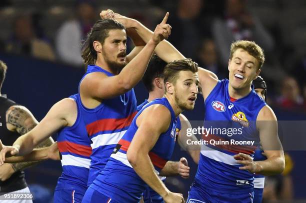 Tom Boyd of the Bulldogs is congratulated by team mates after kicking a goal during the AFL round six match between the Western Bulldogs and Carlton...