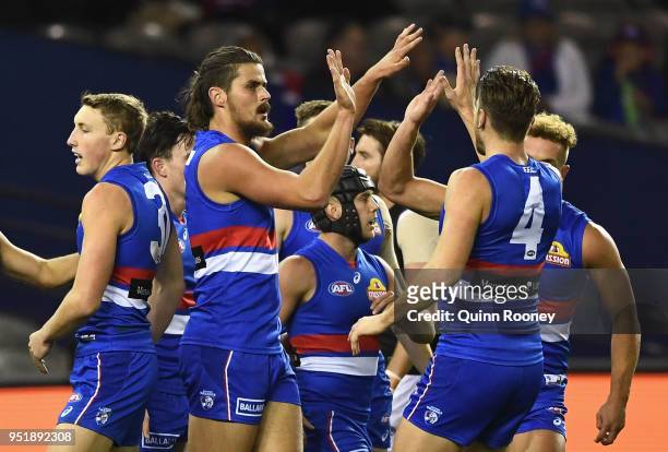 Tom Boyd of the Bulldogs is congratulated by team mates after kicking a goal during the AFL round six match between the Western Bulldogs and Carlton...