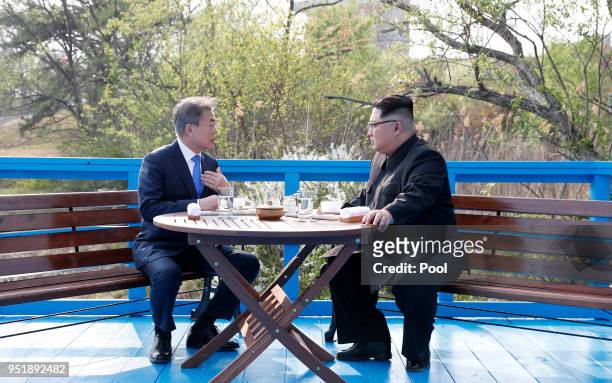 North Korean leader Kim Jong Un and South Korean President Moon Jae-in talk in private during the Inter-Korean Summit on April 27, 2018 in Panmunjom,...