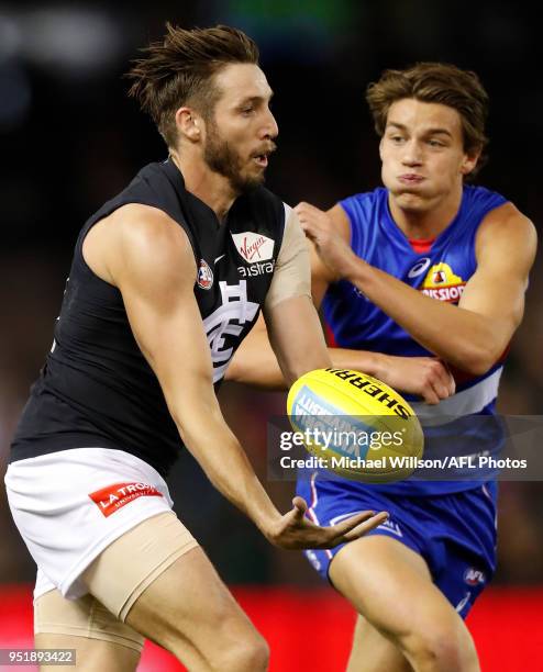 Dale Thomas of the Blues and Patrick Lipinski of the Bulldogs in action during the 2018 AFL round six match between the Western Bulldogs and the...