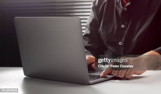 hacker on computer at night - coding laptop stock pictures, royalty-free photos & images