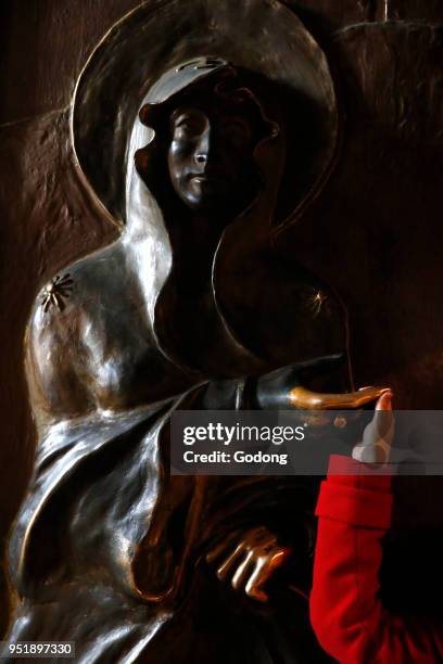 Santa Maria Maggiore's church, Rome. Faithful touching the Holy Door. Italy.