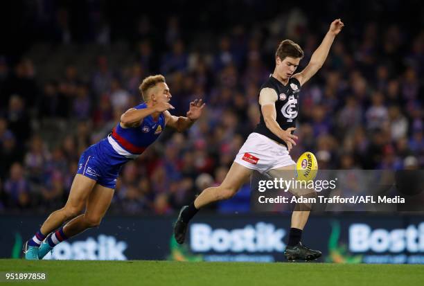 Paddy Dow of the Blues in action ahead of Mitch Wallis of the Bulldogs during the 2018 AFL round six match between the Western Bulldogs and the...