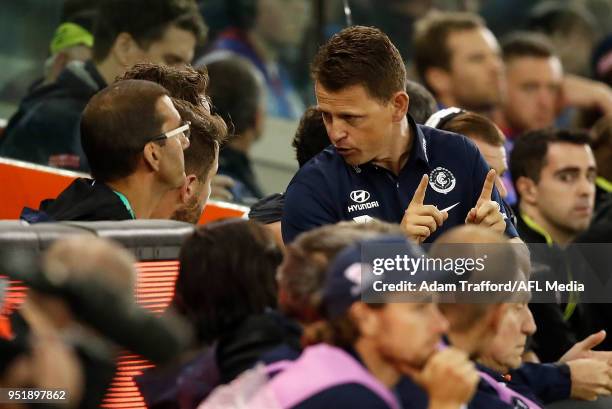 Brendon Bolton, Senior Coach of the Blues speaks to players on the interchange bench during the 2018 AFL round six match between the Western Bulldogs...