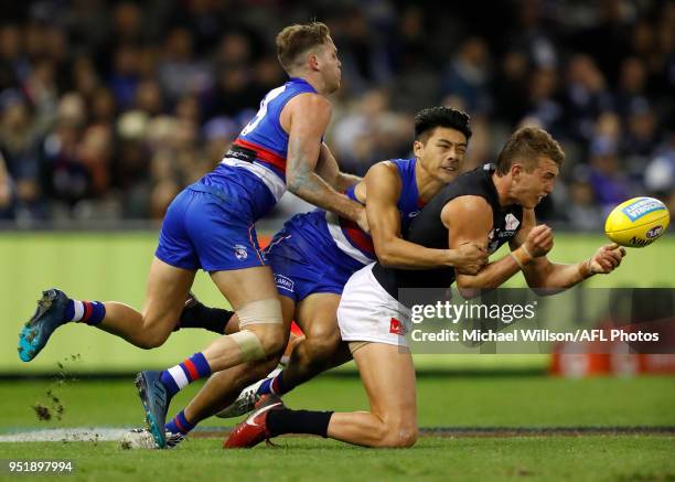 Patrick Cripps of the Blues is tackled by Hayden Crozier and Lin Jong of the Bulldogs during the 2018 AFL round six match between the Western...