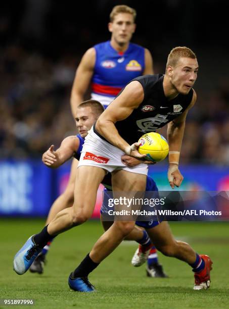 Harry McKay of the Blues is tackled by Caleb Daniel of the Bulldogs during the 2018 AFL round six match between the Western Bulldogs and the Carlton...