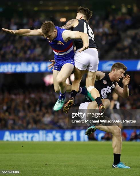 Billy Gowers of the Bulldogs, Sam Rowe of the Blues and Aaron Mullett of the Blues collide during the 2018 AFL round six match between the Western...