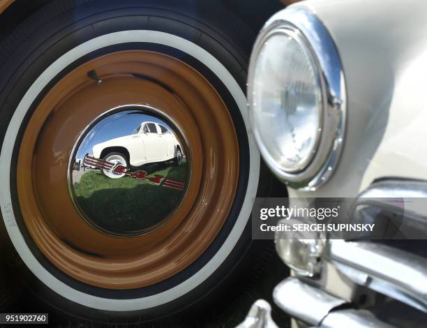 Car is reflected in a hub cap during the opening day of the OldCarLand retro car festival on April 27 in Kiev. - More than 1000 vehicles made in the...