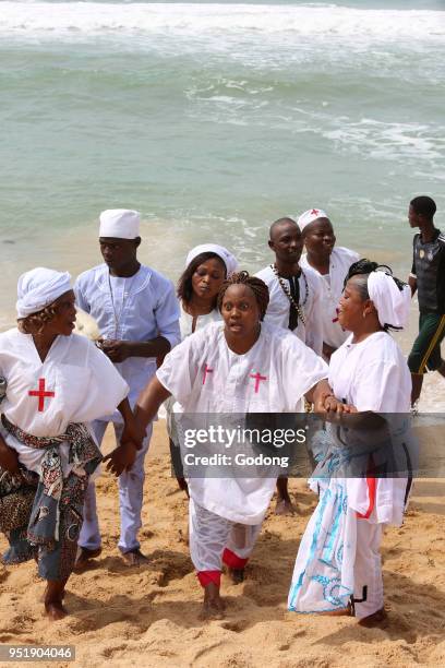 Voodoo cult on a beach in Cotonou, Benin. Tranced woman.