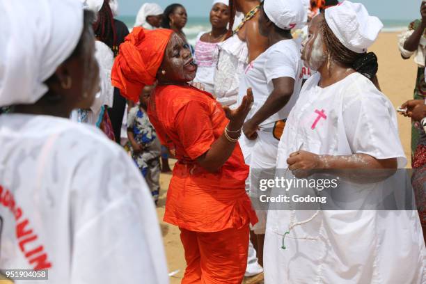 Voodoo cult on a beach in Cotonou, Benin. Tranced woman.