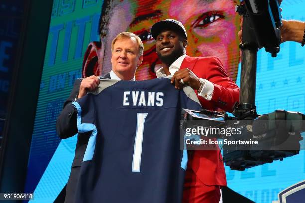 Rashaan Evans holds a jersey and takes photos with NFL Commissioner Roger Goodell after being chosen by the Tennessee Titans with the 22nd pick...