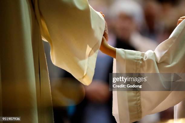 Sunday morning catholic mass. Priest and altar boy. Sallanches, France.