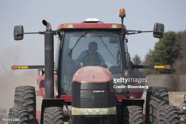 Farmer drives a Case IH Agricultural Equipment Inc. Tractor while planting corn in Princeton, Illinois, U.S., on Tuesday, April 24, 2018. Corn...