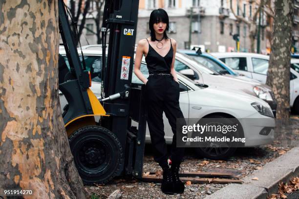 Sora Choi wears an all black outfit including a choker with a large ring, slip top, pants, and platform boots during Milan Fashion Week Fall/Winter...