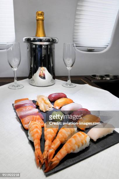PremiAir Learjet 45 G-IZIP interior cabin interior with Champagne and Japanese sushi seafood platter.