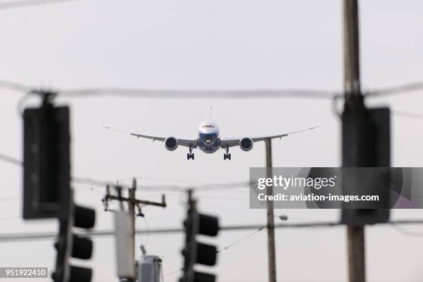 Traffic-lights and telegraph poles with the first Boeing 787-8 Dreamliner prototype on final-approach.