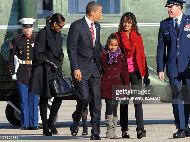 President Barack Obama, First Lady Michelle Obama and their daughters Malia and Sasha arrive to board the Air Force One at the Andrews Air Force Base...