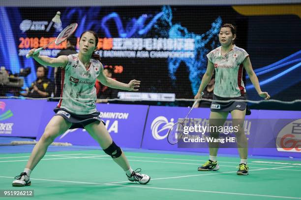 Japan's Ayaka Takahashi and Misaki Matsutomo hits a return during their women's doubles match against Greysia Polii and Apriyani Rahayu of Indonesia...