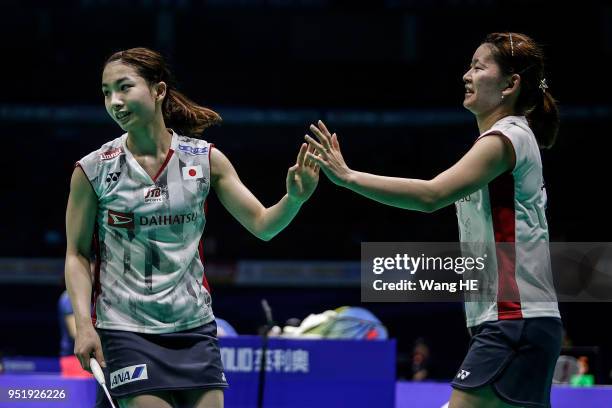 Japan's Ayaka Takahashi and Misaki Matsutomo celebrate winning the game after their women's doubles match against Greysia Polii and Apriyani Rahayu...