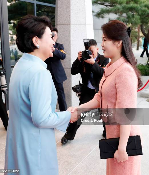 South Korea's first lady Kim Jung-sook shakes hands with North Korean first lady Ri Sol-ju upon arrival at the Peace House on April 27, 2018 in...