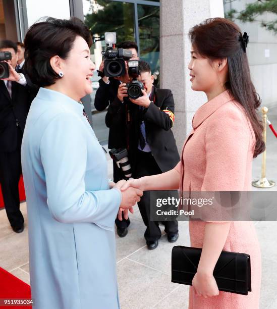 South Korea's first lady Kim Jung-sook shakes hands with North Korean first lady Ri Sol-ju upon arrival at the Peace House on April 27, 2018 in...