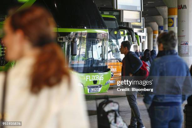 Travelers queue to board FlixBus passenger buses at Munich central bus station in Munich, Germany, on Friday, April 27, 2018. Since introducing a...