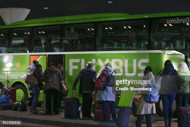 Travelers queue to board a FlixBus passenger bus at Munich central bus station in Munich, Germany, on Friday, April 27, 2018. Since introducing a...