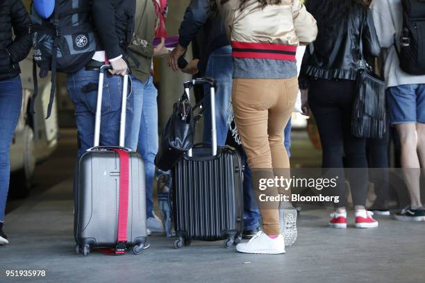 Travelers stand with their luggage at Munich central bus station in Munich, Germany, on Friday, April 27, 2018. Since introducing a handful of routes...