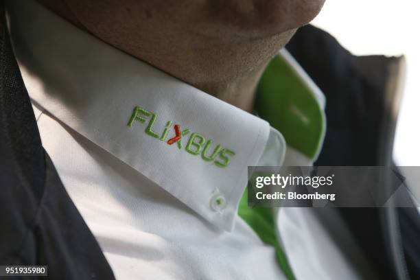 The FlixBus logo sits on a bus driver's shirt collar at Munich central bus station in Munich, Germany, on Friday, April 27, 2018. Since introducing a...
