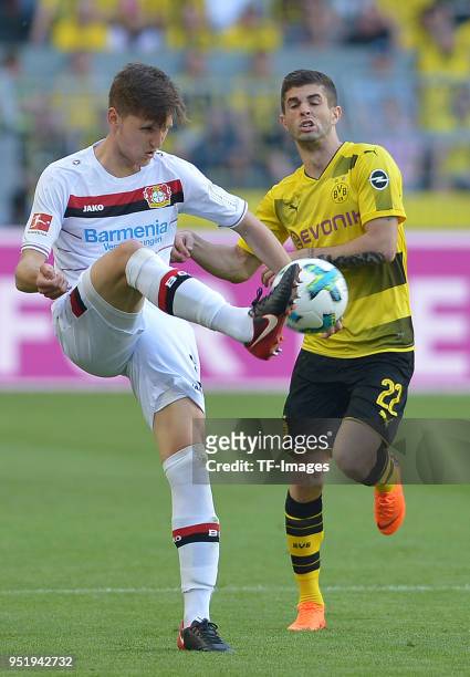 Panagiotis Retsos of Leverkusen and Christian Pulisic of Dortmund battle for the ball during the Bundesliga match between Borussia Dortmund and Bayer...